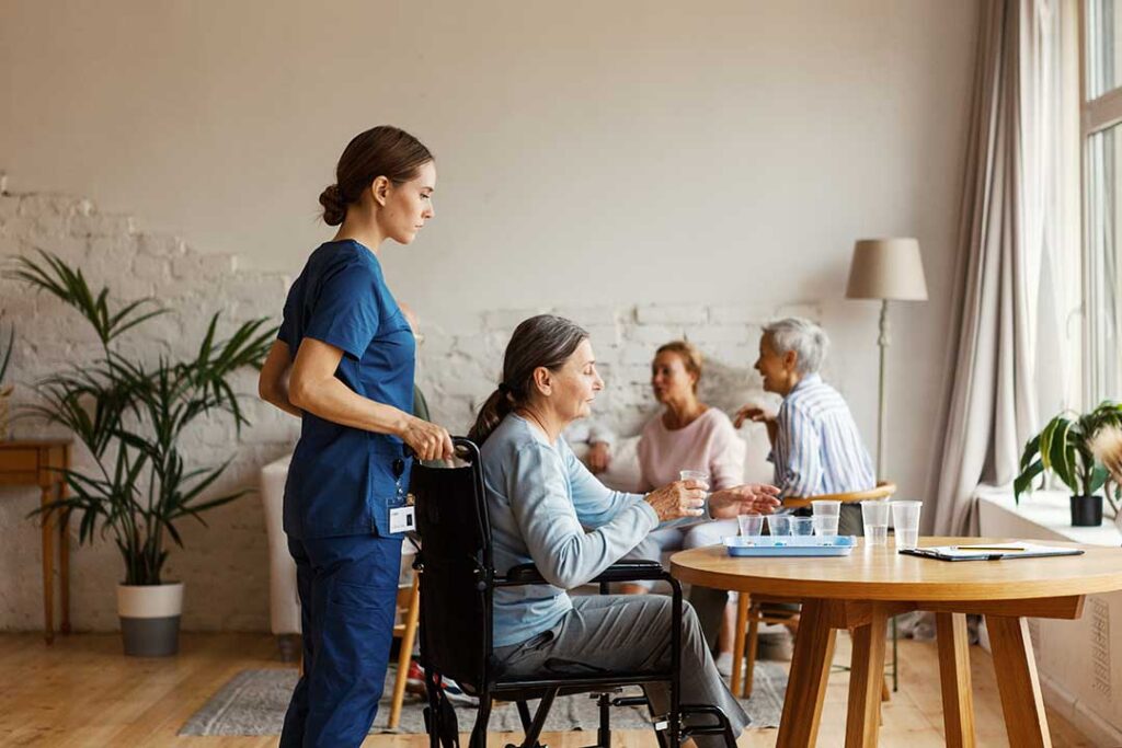 An older adult decorating a cozy living space with family photos and comfortable blankets.