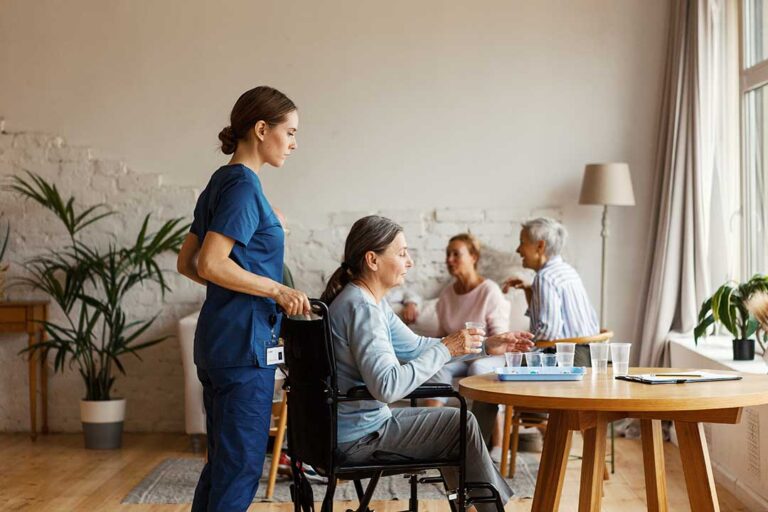 An older adult decorating a cozy living space with family photos and comfortable blankets.
